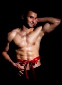 13259083-fashionable-muscular-man-in-a-fashion-pose-with-red-bow
